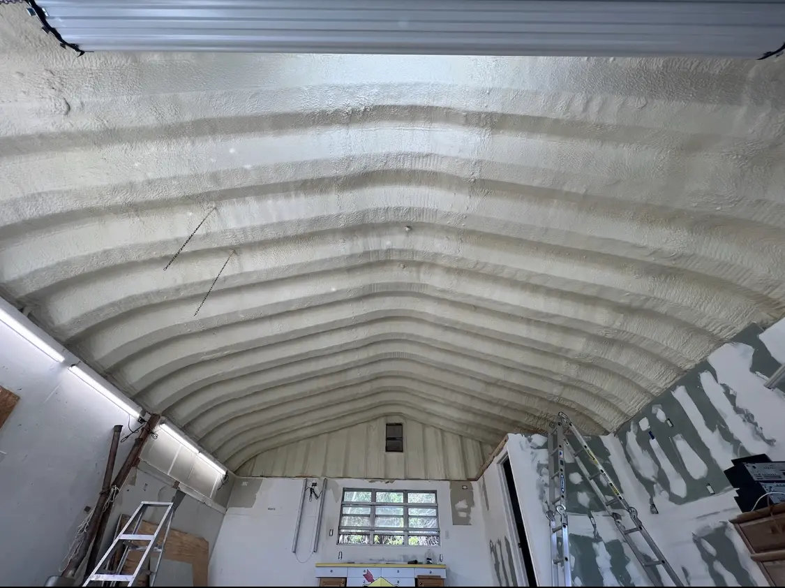 Spray polyurethane foam applied to the underside of a metal roof deck in Calera
